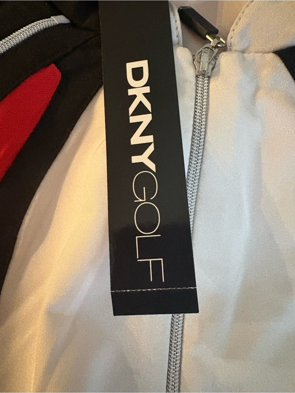 DKNY Golf white sleeveless golf shirt with black Red Trim NWT